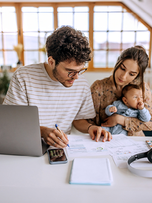 A couple with their baby making a budget