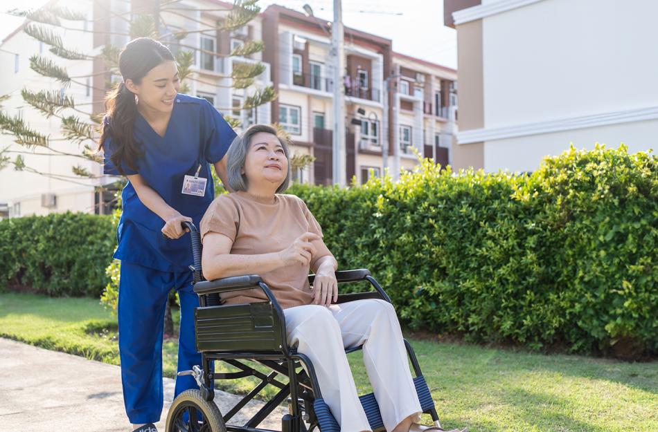 woman pushing another woman in a wheelchair